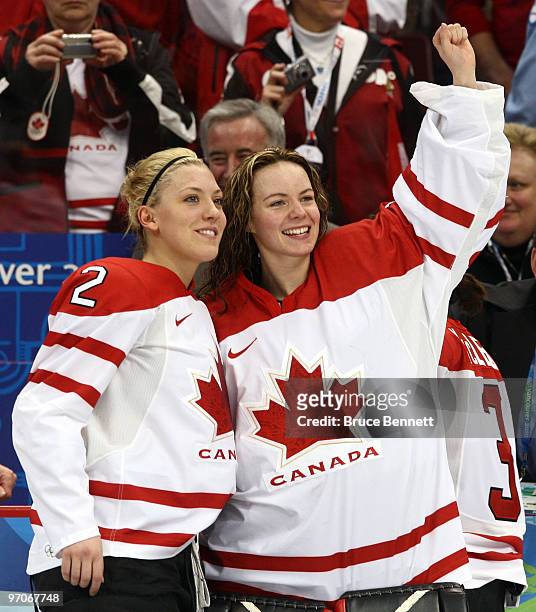 Meghan Agosta and Shannon Szabados of Canada celebrate after receiving the gold medals won during the ice hockey women's gold medal game between...