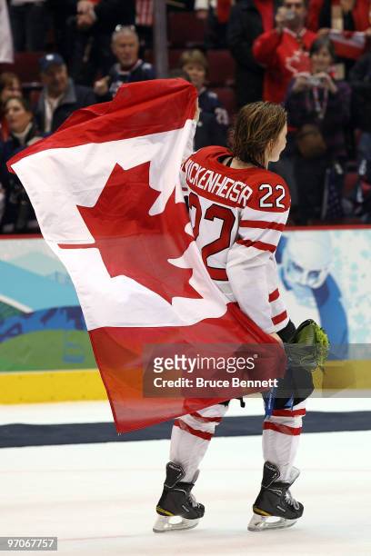 Hayley Wickenheiser of Canada holds her countries flag after winning the gold medal during the ice hockey women's gold medal game between Canada and...