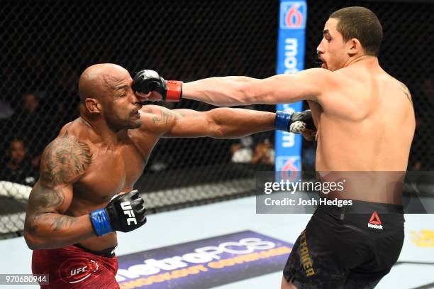 Robert Whittaker of New Zealand punches Yoel Romero of Cuba in their middleweight fight during the UFC 225 event at the United Center on June 9, 2018...