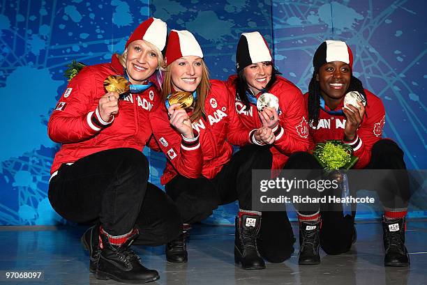 Kaillie Humphries and Heather Moyse of Canada receive the gold medal and Helen Upperton and Shelly-Ann Brown of Canada receive the silver medal...