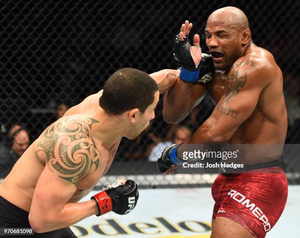 Robert Whittaker of New Zealand punches Yoel Romero of Cuba in their middleweight fight during the UFC 225 event at the United Center on June 9, 2018...