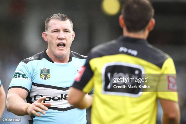 Paul Gallen of the Sharks makes his point to referee Adam Gee during the round 14 NRL match between the Cronulla Sharks and the Wests Tigers at...