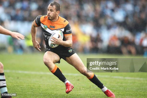 Josh Reynolds of the Tigers runs the ball during the round 14 NRL match between the Cronulla Sharks and the Wests Tigers at Southern Cross Group...