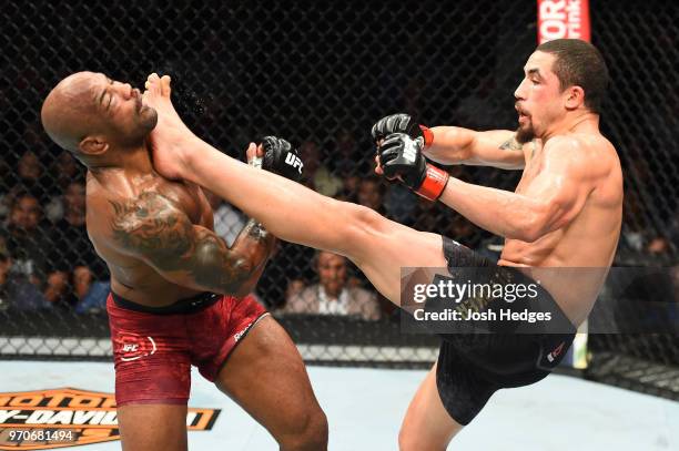 Robert Whittaker of New Zealand lands a front kick to the face of Yoel Romero of Cuba in their middleweight fight during the UFC 225 event at the...