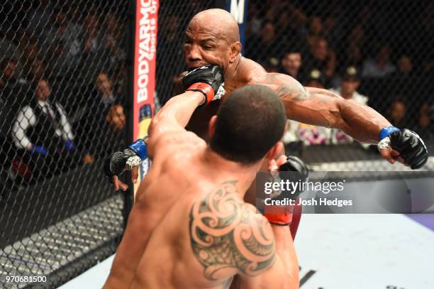 Robert Whittaker of New Zealand punches Yoel Romero of Cuba in their middleweight fight during the UFC 225 event at the United Center on June 9, 2018...