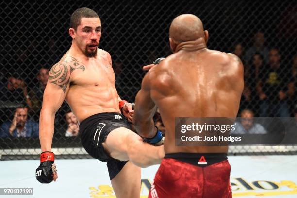 Robert Whittaker of New Zealand kicks Yoel Romero of Cuba in their middleweight fight during the UFC 225 event at the United Center on June 9, 2018...