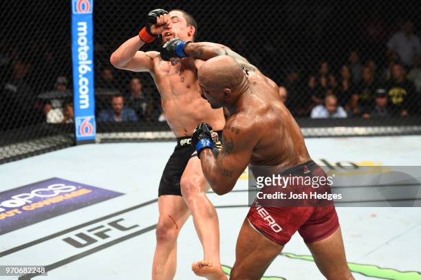 Yoel Romero of Cuba punches Robert Whittaker of New Zealand in their middleweight fight during the UFC 225 event at the United Center on June 9, 2018...