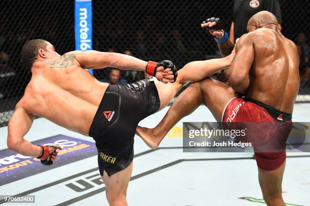 Robert Whittaker of New Zealand kicks Yoel Romero of Cuba in their middleweight fight during the UFC 225 event at the United Center on June 9, 2018...