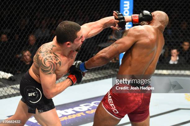 Robert Whittaker of New Zealand punches Yoel Romero of Cuba in their middleweight fight during the UFC 225 event at the United Center on June 9, 2018...