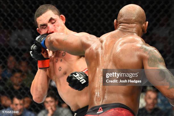 Yoel Romero of Cuba punches Robert Whittaker of New Zealand in their middleweight fight during the UFC 225 event at the United Center on June 9, 2018...