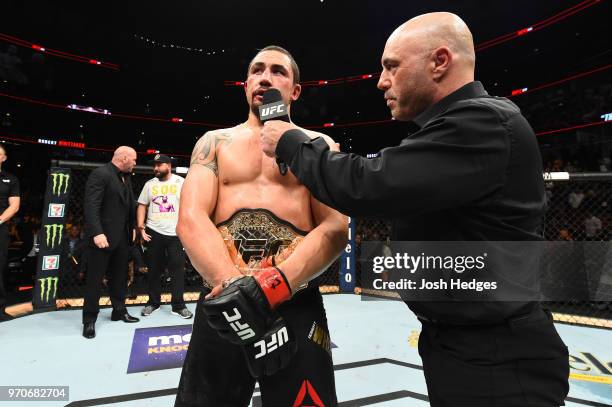 Robert Whittaker of New Zealand is interviewed by Joe Rogan after defeating Yoel Romero of Cuba by split decision in their middleweight fight during...