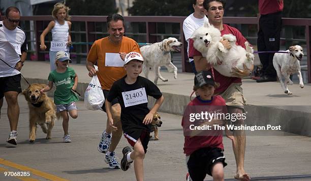 Annapolis, Md. CREDIT: Dominic Bracco II Mark Wilkinson of Eastport, Md. Carries his dog "Iglu" across the Eastport Bridge on Saturday June 14, 2008...