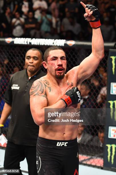 Robert Whittaker of New Zealand reacts after finishing five rounds against Yoel Romero of Cuba in their middleweight fight during the UFC 225 event...
