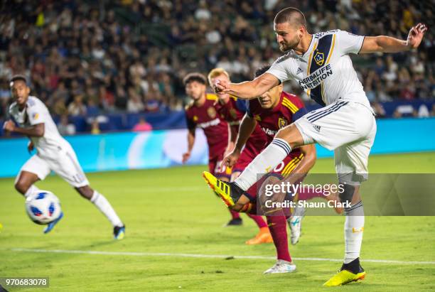 Perry Kitchen of Los Angeles Galaxy takes a shot during the Los Angeles Galaxy's MLS match against FC Dallas at the StubHub Center on June 9, 2018 in...