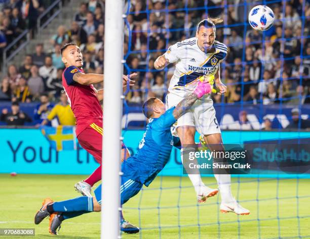 Zlatan Ibrahimovic of Los Angeles Galaxy scores a goal as Nick Rimando of Real Salt Lake tries to defend during the Los Angeles Galaxy's MLS match...