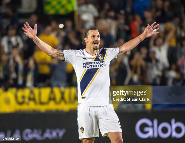 Zlatan Ibrahimovic of Los Angeles Galaxy celebrates his second goal of the game as Justen Glad of Real Salt Lake tries to defend during the Los...