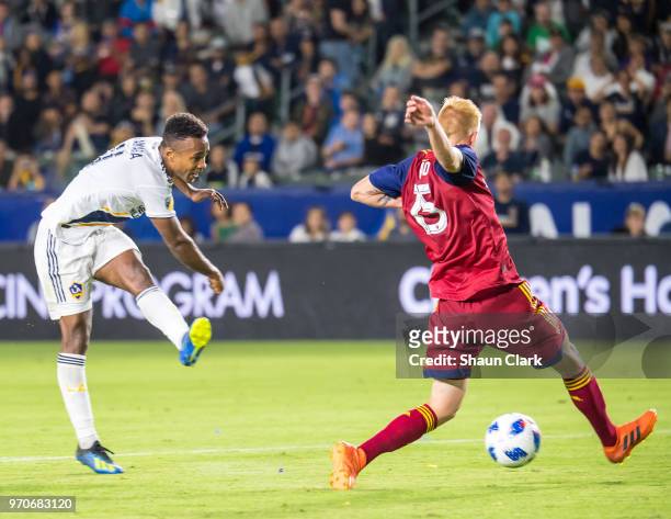 Ola Kamara of Los Angeles Galaxy scores a goal as Justen Glad of Real Salt Lake defends during the Los Angeles Galaxy's MLS match against FC Dallas...