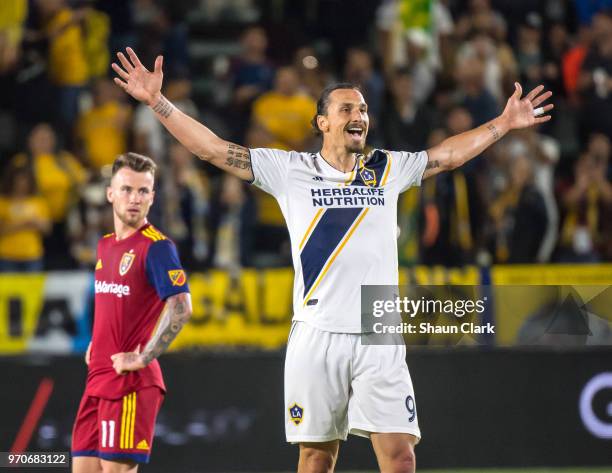 Zlatan Ibrahimovic of Los Angeles Galaxy celebrates his second goal of the game as Justen Glad of Real Salt Lake tries to defend during the Los...