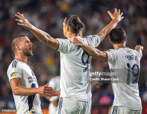 Zlatan Ibrahimovic of Los Angeles Galaxy celebrates his second goal of the game as Justen Glad of Real Salt Lake tries to defend during the Los...