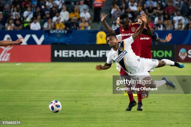 Los Angeles Galaxy forward Ola Kamara takes a fall in front of Real Salt Lake midfielder Sunday Stephen during the LA Galaxy game against Real Salt...