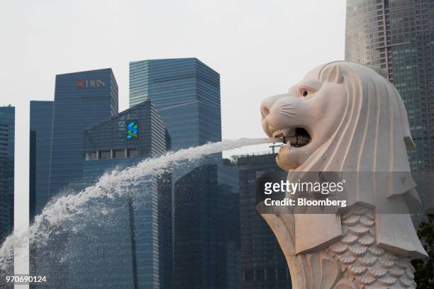 The Merlion statue stands at the Marina Bay waterfront as commercial buildings stand in the central business district in Singapore, on Sunday, June...