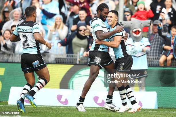 Sione Katoa, Edrick Lee and Valentine Holmes of the Sharks celebrate Holmes scoring a try during the round 14 NRL match between the Cronulla Sharks...