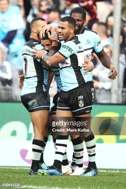 Jayson Bukuya, Sione Katoa, Edrick Lee and Valentine Holmes of the Sharks celebrate Holmes scoring a try during the round 14 NRL match between the...