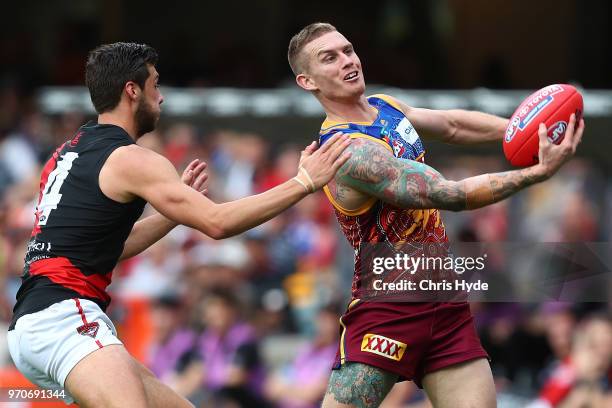 Dayne Beams of the Lions handballs during the round 12 AFL match between the Brisbane Lions and the Essendon Bombers at The Gabba on June 10, 2018 in...