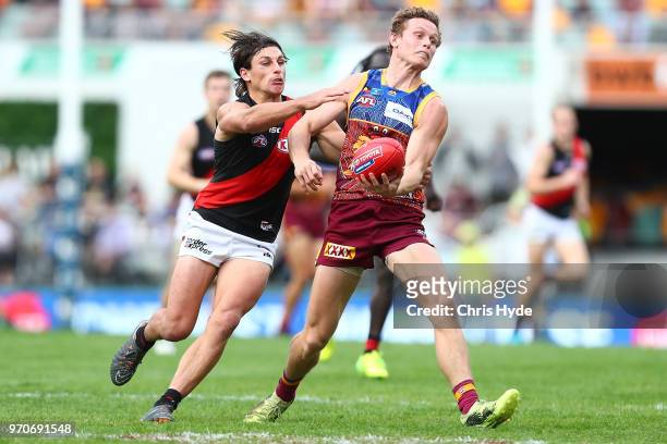 Ryan Lester of the Lions handballs during the round 12 AFL match between the Brisbane Lions and the Essendon Bombers at The Gabba on June 10, 2018 in...