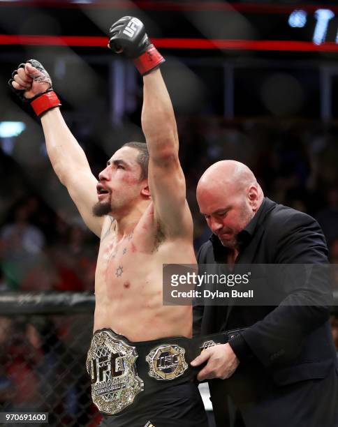 Robert Whittaker of New Zealand celebrates as UFC President Dana White gives him the middleweight title belt after defeating Yoel Romero of Cuba...