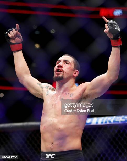 Robert Whittaker of New Zealand celebrates after his middleweight title fight against Yoel Romero of Cuba during the UFC 225: Whittaker v Romero 2...