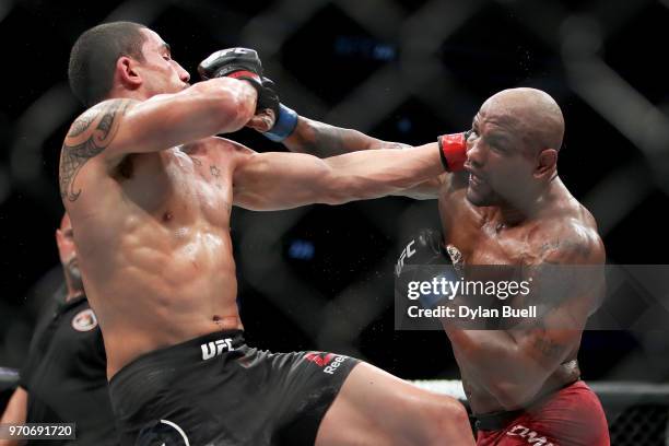 Yoel Romero of Cuba and Robert Whittaker of New Zealand each attempt a punch in the fifth round in their middleweight title fight during the UFC 225:...