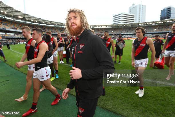 Dyson Heppell leads the Bombers leaves the field after winning the round 12 AFL match between the Brisbane Lions and the Essendon Bombers at The...