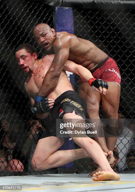 Yoel Romero of Cuba attempts to take down Robert Whittaker of New Zealand in the fifth round in their middleweight title fight during the UFC 225:...