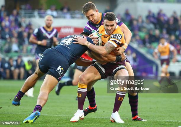 Darius Boyd of the Broncos is tackled during the round 14 NRL match between the Melbourne Storm and the Brisbane Broncos at AAMI Park on June 10,...