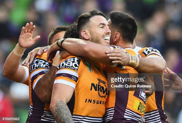 Darius Boyd of the Broncos is congratulated by team mates after scoring a try during the round 14 NRL match between the Melbourne Storm and the...