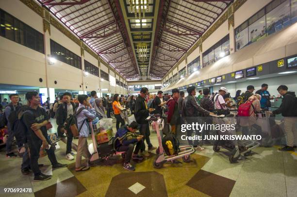 Passengers wait for their flights at the Juanda Surabaya International airport in Sidoarjo, East Java, on June 10 as Indonesians begin the mass...