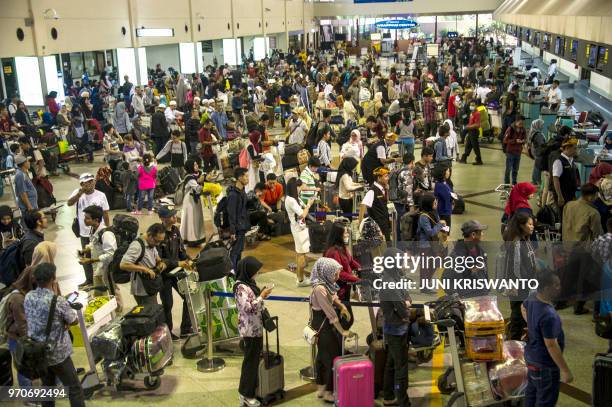 Passengers wait for their flights at the Juanda Surabaya International airport in Sidoarjo, East Java, on June 10 as Indonesians begin the mass...