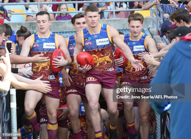 Dayne Zorko of the Lions leads his team out during the 2018 AFL round 12 match between the Brisbane Lions and the Essendon Bombers at The Gabba on...