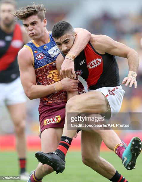 Ben Keays of the Lions contests with Adam Saad of the Bombers during the 2018 AFL round 12 match between the Brisbane Lions and the Essendon Bombers...
