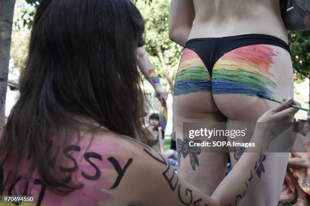 Woman participant seen painting another woman's buttocks at the pride festival. This year's Pride theme was discrimination against women, with...