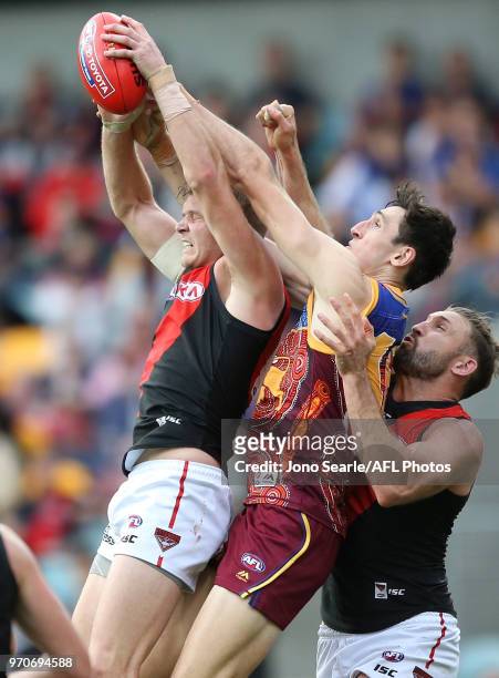 Michael Hurley of the Bombers contests the ball with Oscar McInerney of the Lions during the 2018 AFL round 12 match between the Brisbane Lions and...