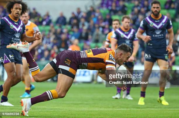 Darius Boyd of the Broncos scores the first try during the round 14 NRL match between the Melbourne Storm and the Brisbane Broncos at AAMI Park on...