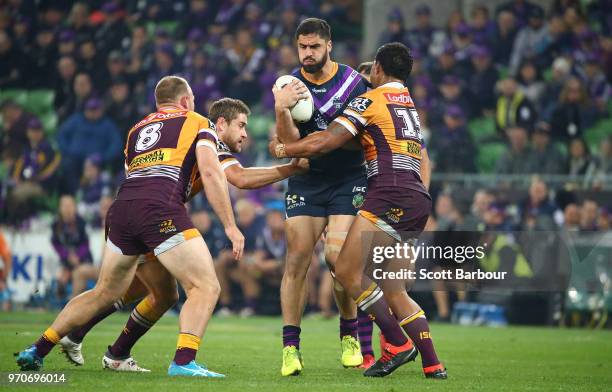 Jesse Bromwich of the Melbourne Storm is tackled during the round 14 NRL match between the Melbourne Storm and the Brisbane Broncos at AAMI Park on...