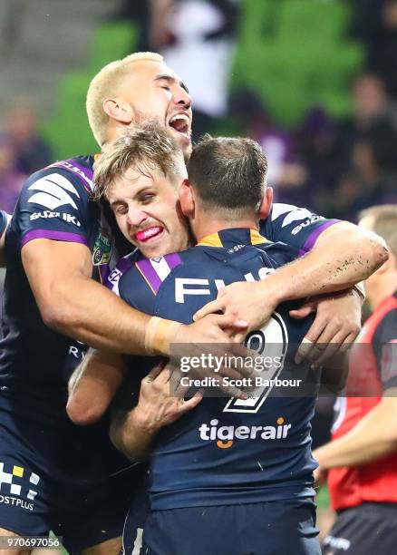 Cameron Munster of the Melbourne Storm celebrates after scoring a try with Cameron Smith of the Melbourne Storm during the round 14 NRL match between...