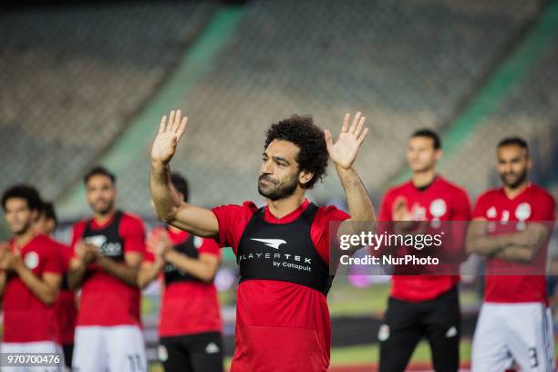 Egypt's national team footballer and Liverpool's forward Mohamed Salah greets fans during the final training session at Cairo international stadium...