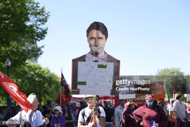 Protesters with a cut out of Justin Trudeau during a rally to protest the G7 summit in Quebec City, Canada on 9 June 2018. During the last day of the...