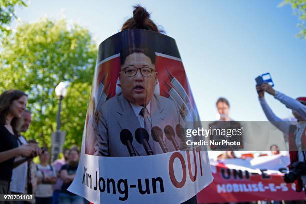 Anti Justin Trudeau and anti Kim Jong-un supporters with cut out and banners during a rally to protest the G7 summit in Quebec City, Canada on 9 June...