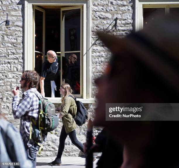 An onlooker witnessing the rally from a window during a rally to protest the G7 summit in Quebec City, Canada on 9 June 2018. During the last day of...