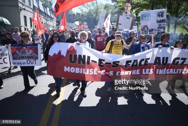 Protesters with a cut out of Justin Trudeau during a rally to protest the G7 summit in Quebec City, Canada on 9 June 2018. During the last day of the...